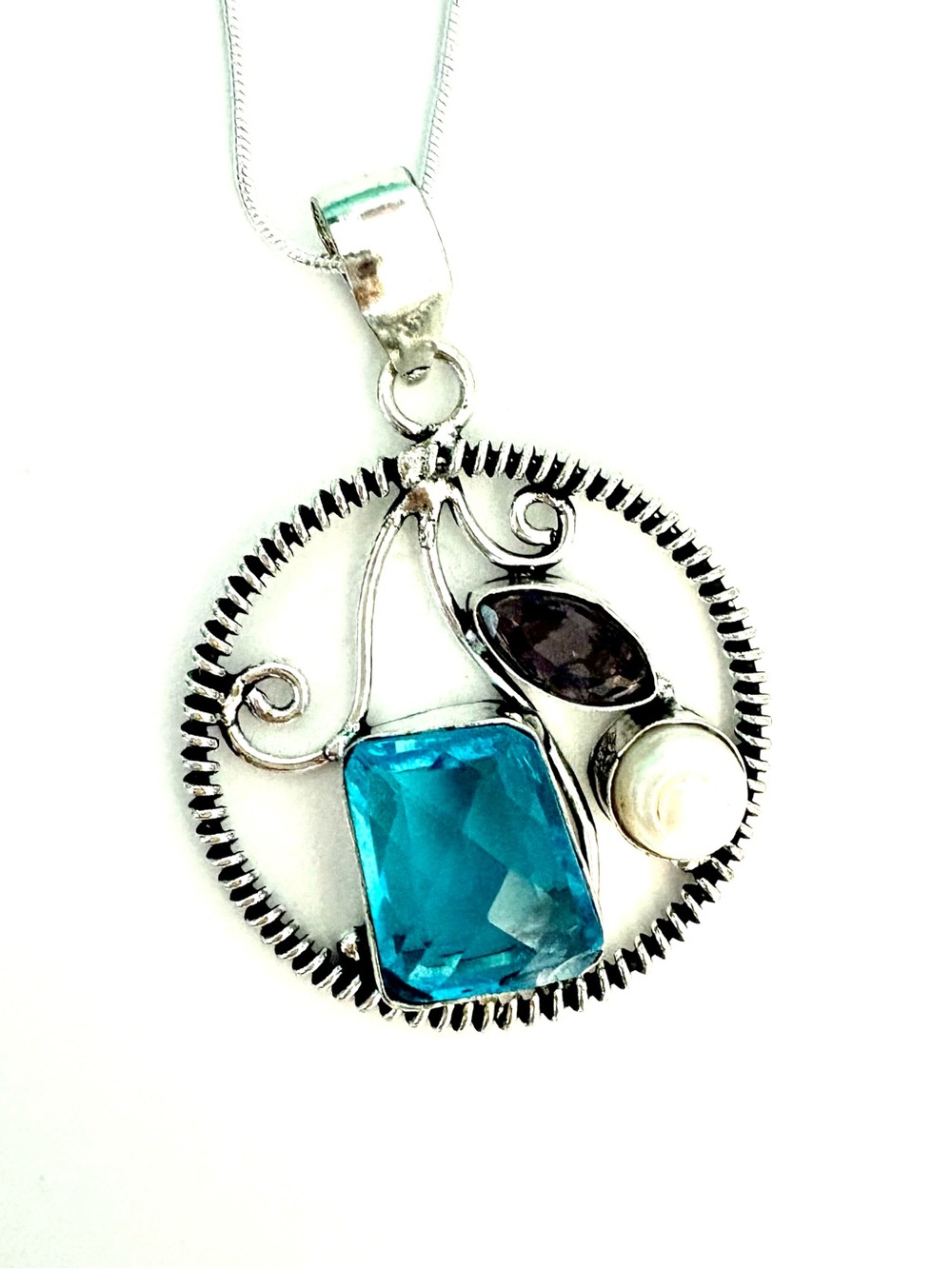2 inch, 925 marked, Blue Topaz, Amethyst, and Pearl pendant on a silver chain.